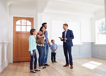 A realtor shows a house to a family
