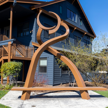 Large, brown, abstract metal sculpture. 