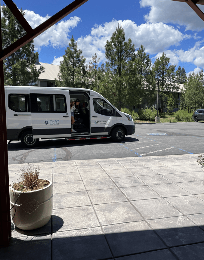 Young girl stepping off the TART Connect shuttle. 