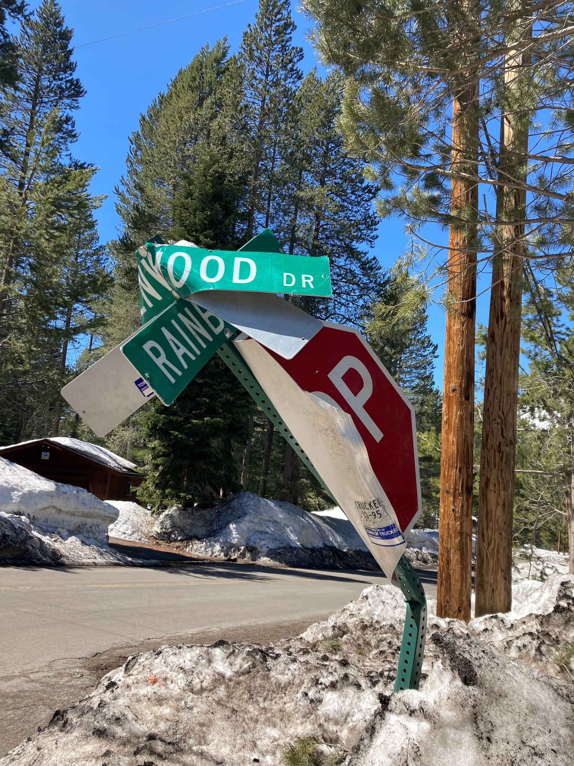 A bent sign post with bent street signs