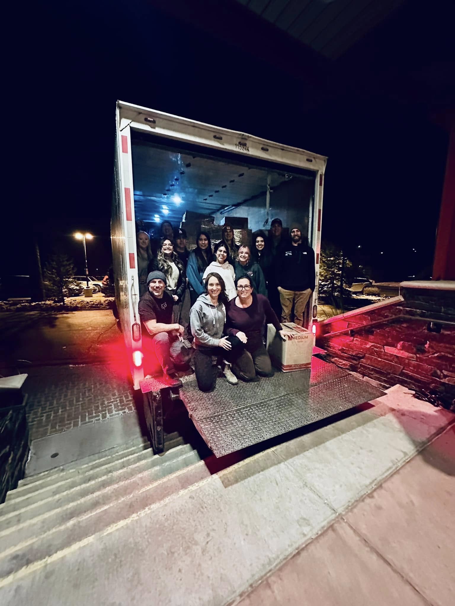 24 foot box truck with people kneeing in the back. 
