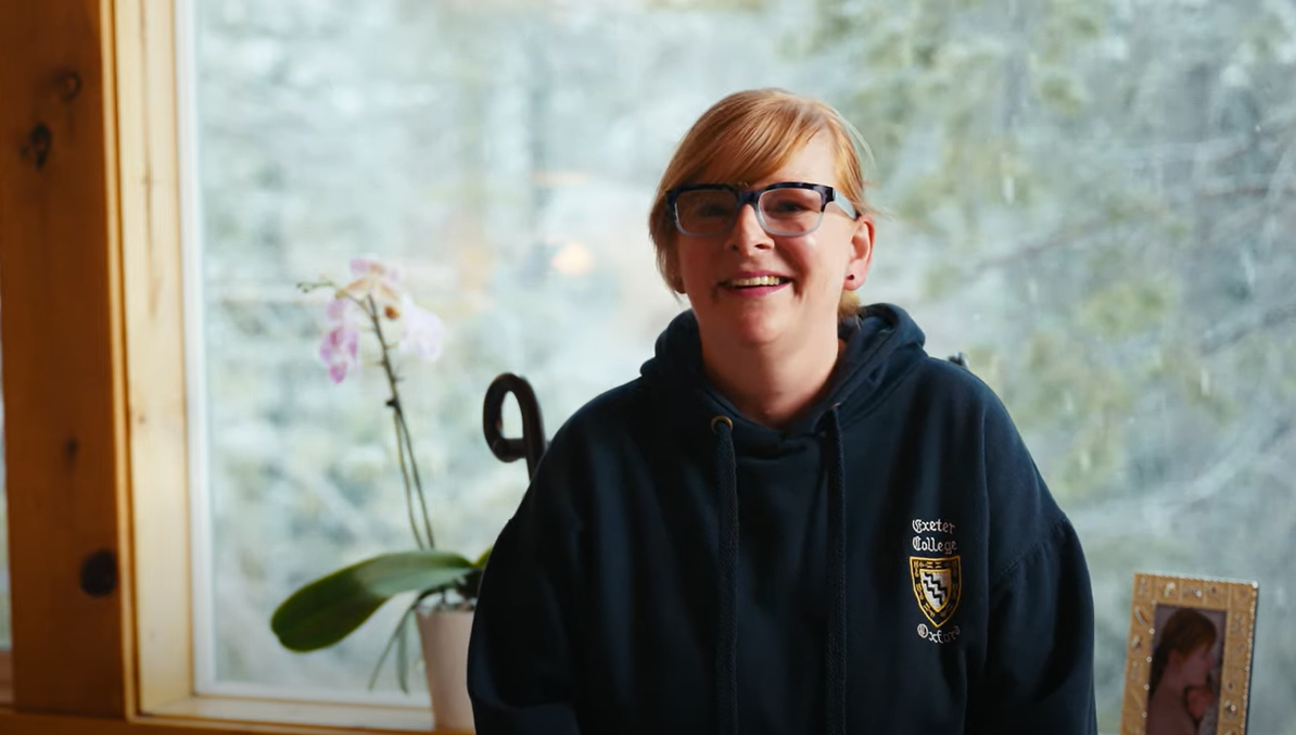 Women being interviewed in a room smiling at the camera. 