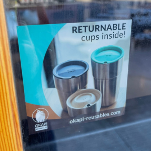Sticker on a window encouraging the use of the return program. 